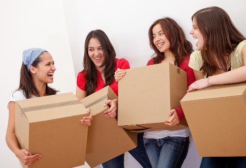Helper carrying boxes during a Paddington flat move