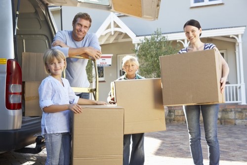 Trained movers carrying boxes with safety awareness